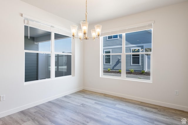 3786 S 4250 W Unit 427, West Haven, UT 84401 - unfurnished room featuring a chandelier, baseboards, wood finished floors, and healthy amount of natural light