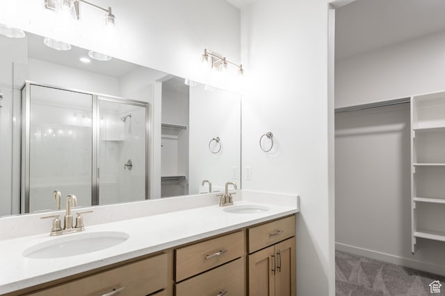 3786 S 4250 W Unit 427, West Haven, UT 84401 - bathroom featuring a spacious closet, double vanity, a stall shower, and baseboards