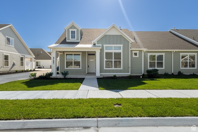 3786 S 4250 W Unit 427, West Haven, UT 84401 - view of front of home featuring board and batten siding, a front yard, a porch, and roof with shingles