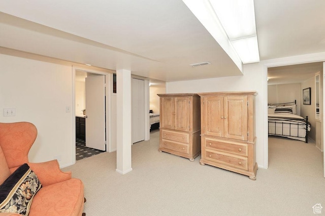 living area featuring light carpet and baseboards