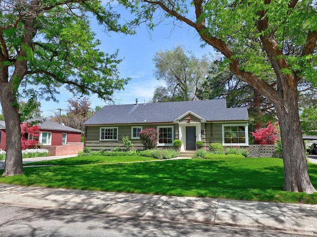 ranch-style home with a front yard