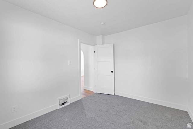 empty room featuring carpet flooring and baseboards