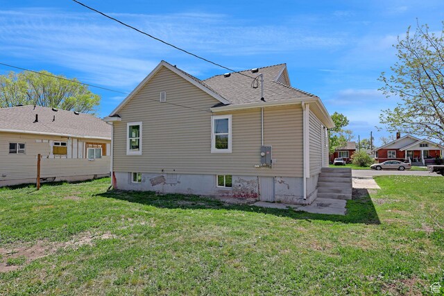 rear view of house with a lawn