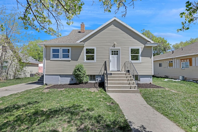 bungalow-style house with a front yard, a chimney, and a shingled roof