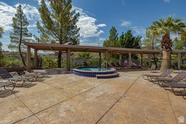 view of patio / terrace with a community hot tub and fence