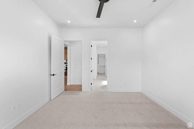 unfurnished bedroom with light carpet, recessed lighting, baseboards, and ceiling fan
