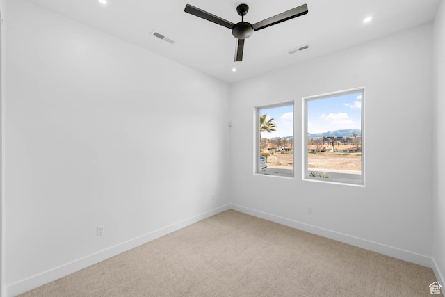 empty room with a ceiling fan, light colored carpet, baseboards, and recessed lighting