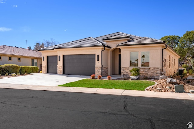 view of front of house featuring stone siding, a garage, driveway, and stucco siding