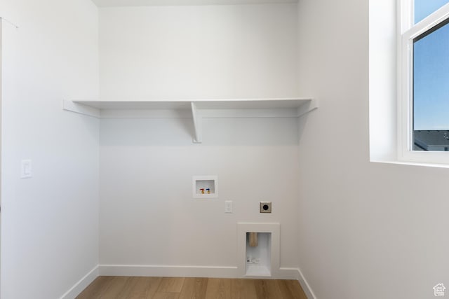 3573 W 725 S Unit 106, West Weber, UT 84401 - laundry room with wood finished floors, hookup for an electric dryer, and washer hookup