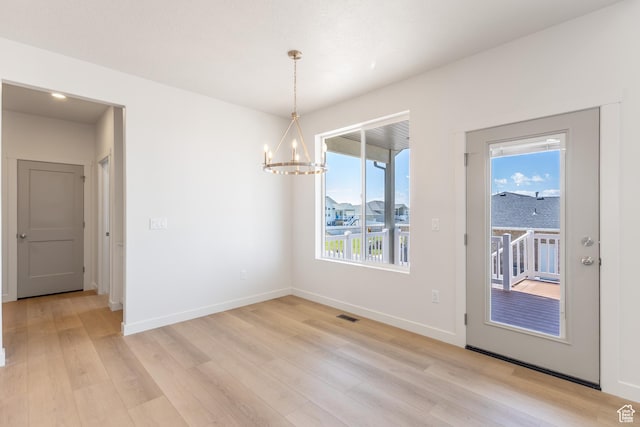3573 W 725 S Unit 106, West Weber, UT 84401 - unfurnished dining area featuring a chandelier and light wood-style floors