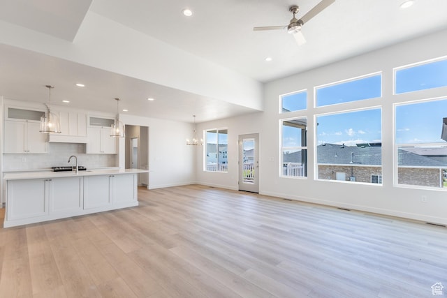 3573 W 725 S Unit 106, West Weber, UT 84401 - kitchen featuring a chandelier, white cabinets, light countertops, recessed lighting, and backsplash