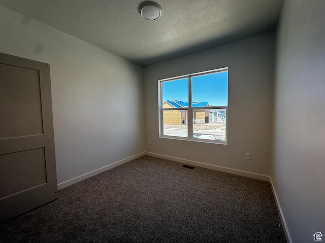 unfurnished room with baseboards, carpet floors, and a textured ceiling