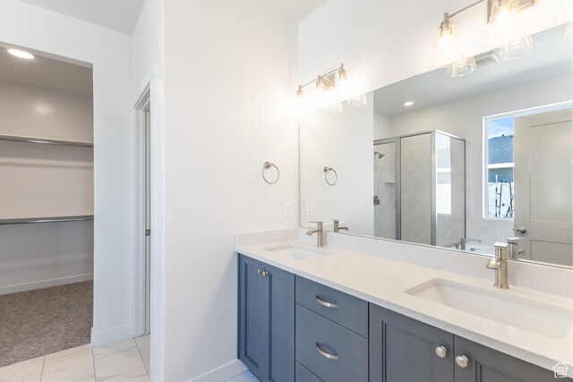 3573 W 725 S Unit 106, West Weber, UT 84401 - bathroom featuring a shower stall, double vanity, a spacious closet, and marble look tiles