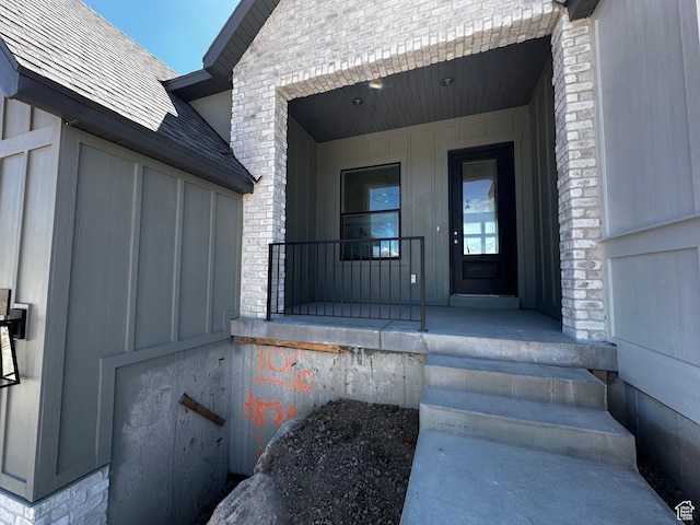 view of exterior entry with covered porch
