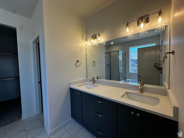 full bath featuring a shower stall, marble finish flooring, double vanity, baseboards, and a bath