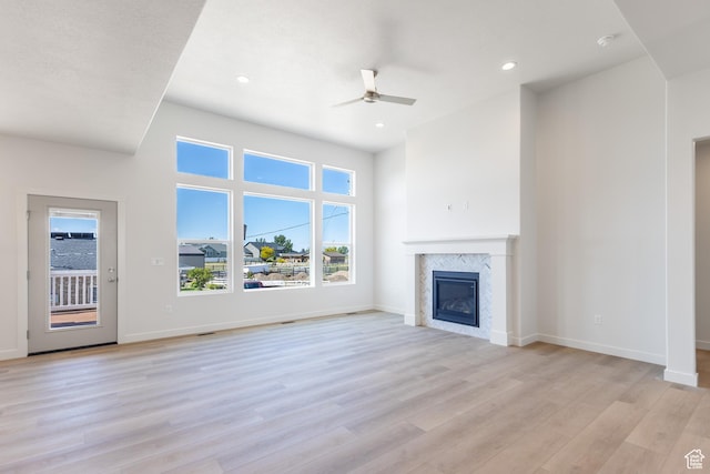3573 W 725 S Unit 106, West Weber, UT 84401 - unfurnished living room featuring ceiling fan, light wood-style flooring, a high end fireplace, and recessed lighting
