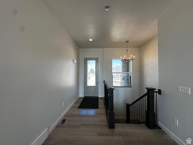 foyer with a chandelier, wood finished floors, baseboards, and recessed lighting