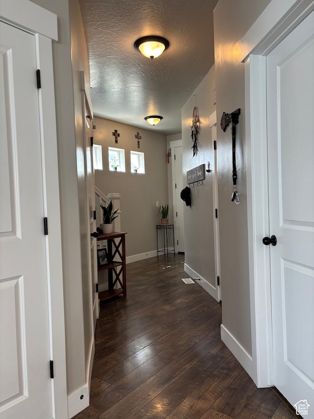 4317 W Quiet Shade Dr, Herriman, UT 84096 - hall with a textured ceiling, dark wood finished floors, and baseboards