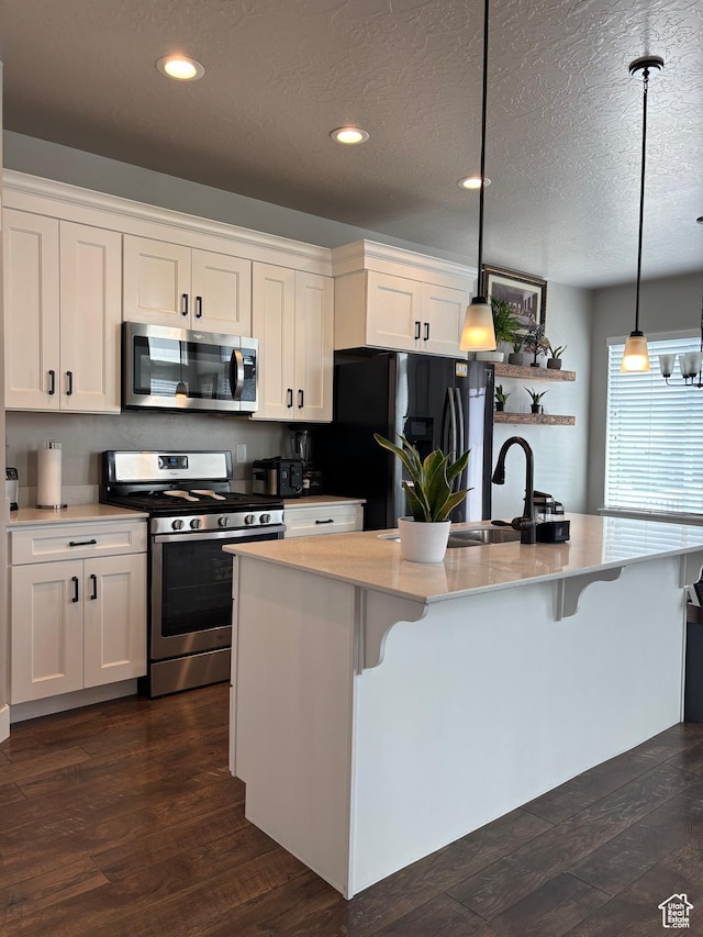 4317 W Quiet Shade Dr, Herriman, UT 84096 - kitchen with appliances with stainless steel finishes, white cabinetry, a breakfast bar area, a sink, and recessed lighting