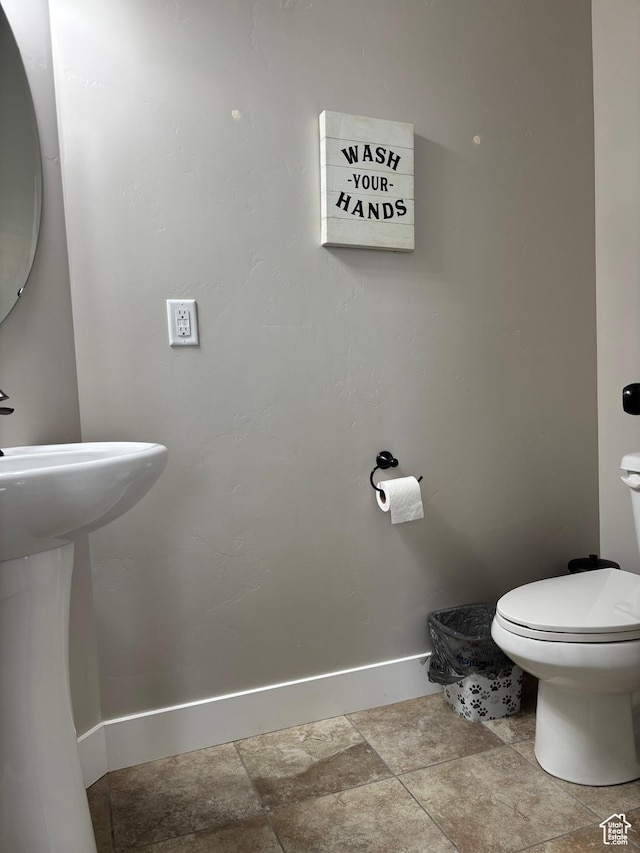 4317 W Quiet Shade Dr, Herriman, UT 84096 - bathroom with baseboards, toilet, stone finish floors, and a sink