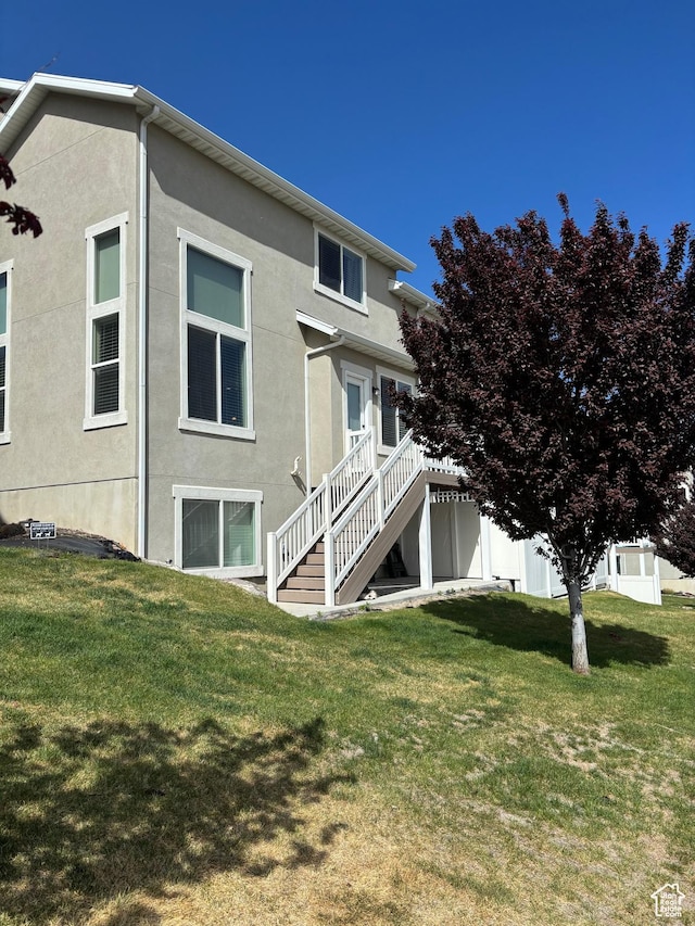 4317 W Quiet Shade Dr, Herriman, UT 84096 - back of house with stairs, stucco siding, and a yard