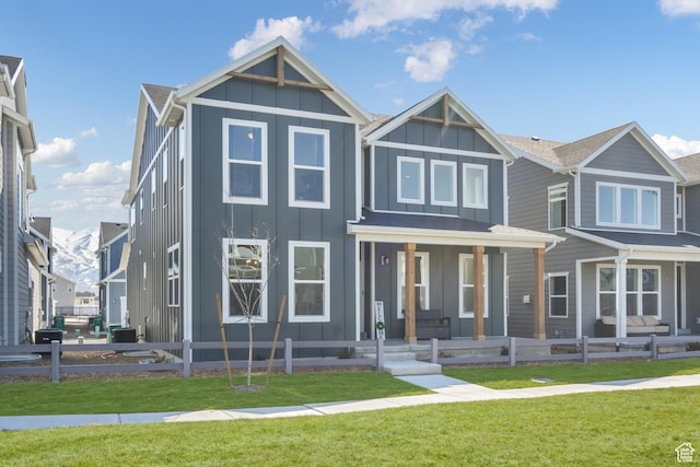 view of front facade featuring board and batten siding, a porch, and central AC