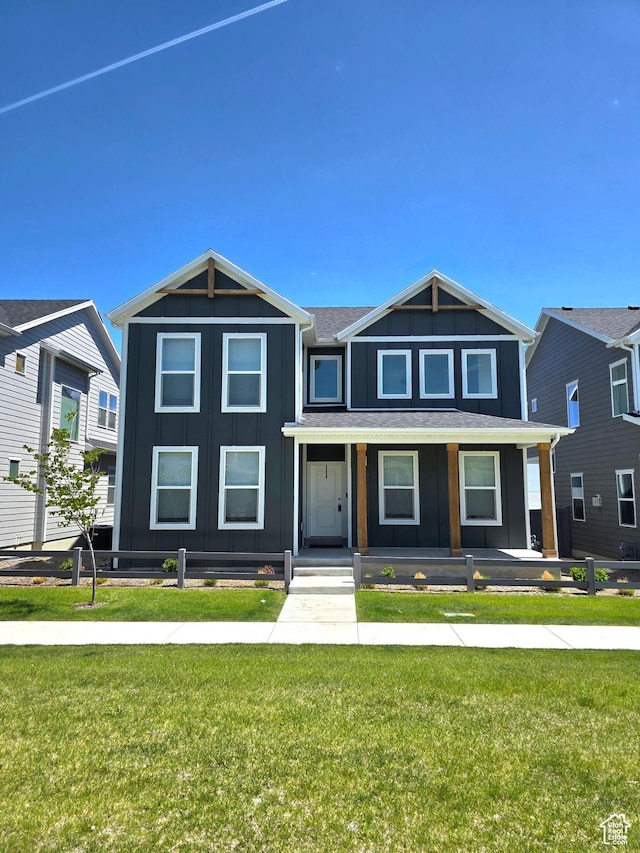 view of front of home featuring a porch, board and batten siding, and a front lawn