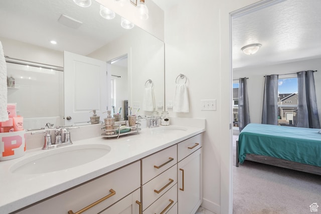 full bathroom featuring double vanity and ensuite bathroom