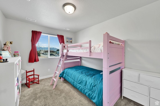 bedroom featuring carpet flooring, a textured ceiling, and baseboards