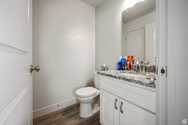 2460 W 450 N Unit 7, Tremonton, UT 84337 - bathroom featuring wood finished floors, toilet, vanity, and baseboards