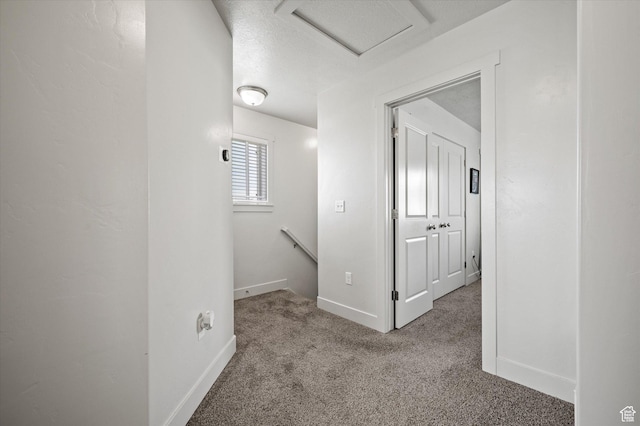 2460 W 450 N Unit 7, Tremonton, UT 84337 - hall featuring an upstairs landing, attic access, carpet, and baseboards