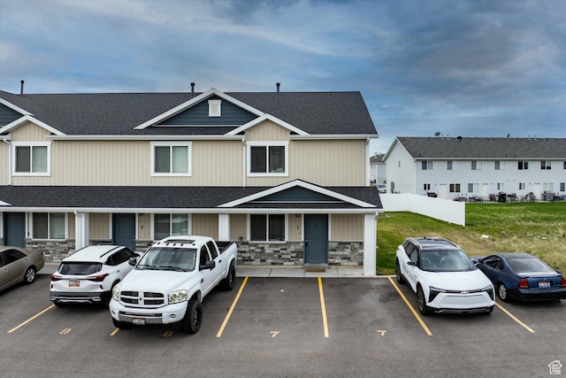 2460 W 450 N Unit 7, Tremonton, UT 84337 - view of front of house with stone siding, uncovered parking, and a shingled roof