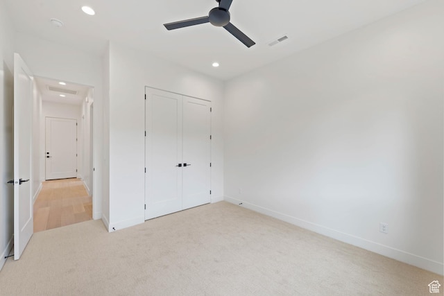 unfurnished bedroom with light carpet, recessed lighting, baseboards, a closet, and ceiling fan