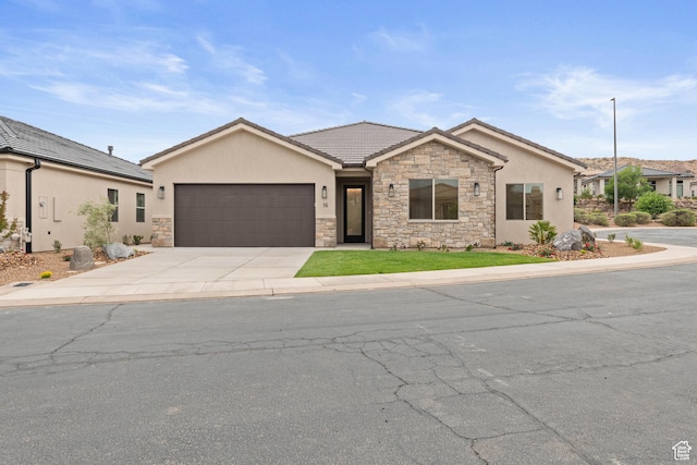 single story home with stone siding, an attached garage, driveway, and stucco siding