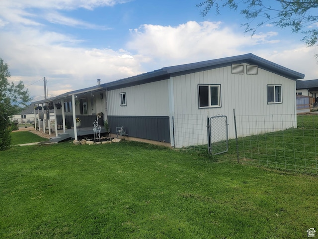 rear view of property with a yard