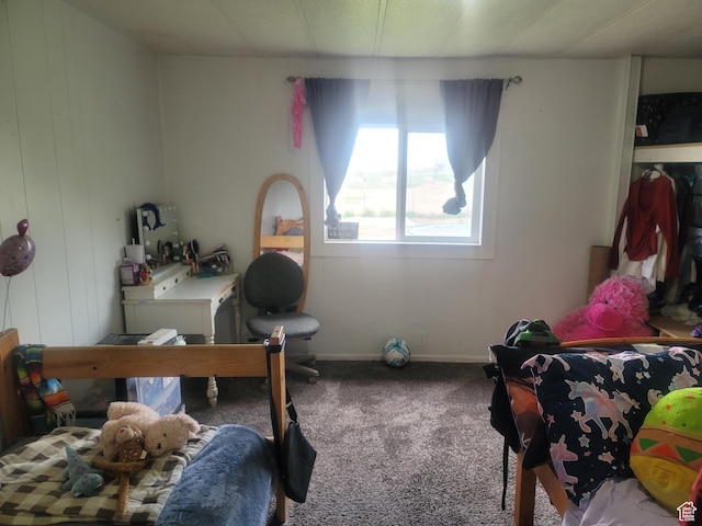 bedroom with carpet flooring and baseboards