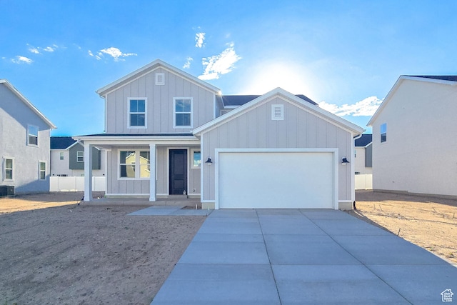 1677 N 800 W, Salem, UT 84653 - traditional home featuring board and batten siding, a porch, a garage, concrete driveway, and cooling unit