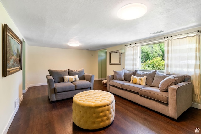 804 E 100 N, Logan, UT 84321 - living room featuring baseboards, dark wood-type flooring, and a textured ceiling