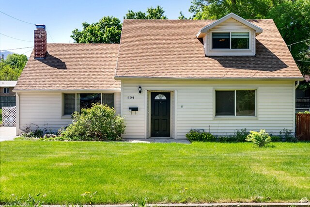804 E 100 N, Logan, UT 84321 - cape cod house with a front yard, a shingled roof, and a chimney
