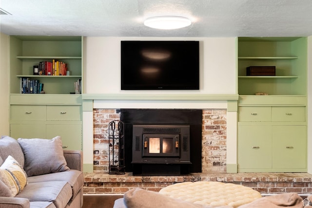 804 E 100 N, Logan, UT 84321 - living area featuring a textured ceiling, built in shelves, a brick fireplace, and wood finished floors