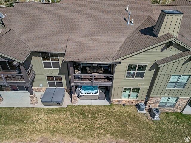 14295 N Council Fire Trl, Kamas, UT 84036 - rear view of property with board and batten siding, a patio area, stone siding, a yard, and roof with shingles