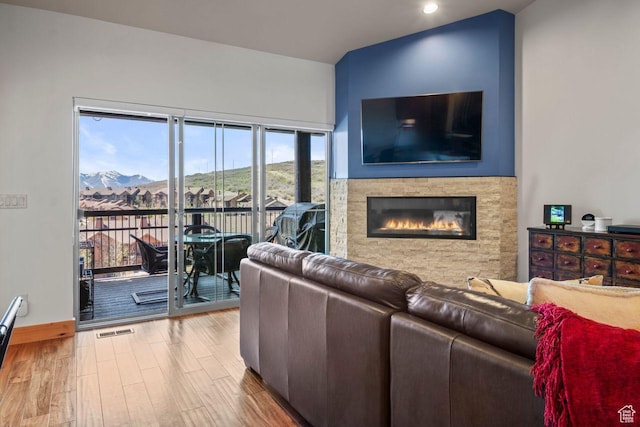 14295 N Council Fire Trl, Kamas, UT 84036 - living room featuring a glass covered fireplace, wood finished floors, recessed lighting, and baseboards