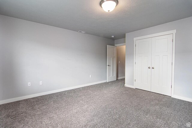 4129 W Miner Vw, Herriman, UT 84096 - unfurnished bedroom with baseboards, carpet, a closet, and a textured ceiling