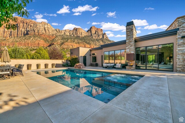 1203 Canyon Springs Rd, Springdale, UT 84767 - view of pool with a patio area, a pool with connected hot tub, an outdoor living space, and a mountain view