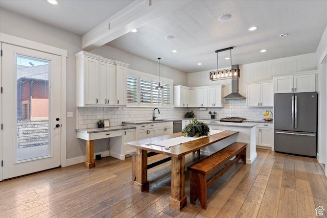 5707 Scenic Ln, Mountain Green, UT 84050 - kitchen with stainless steel appliances, wall chimney range hood, a sink, white cabinets, and recessed lighting