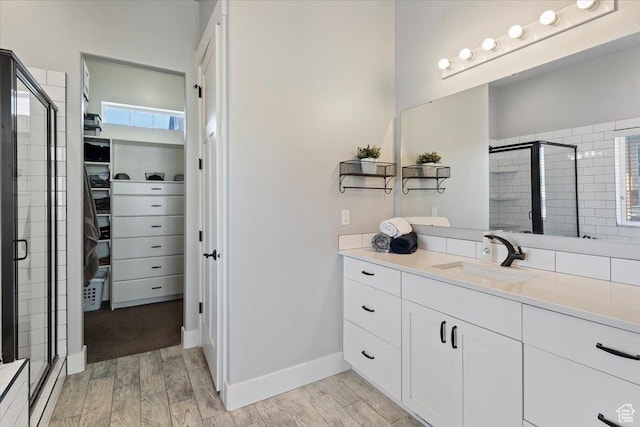 5707 Scenic Ln, Mountain Green, UT 84050 - bathroom featuring a spacious closet, a stall shower, wood finish floors, and vanity