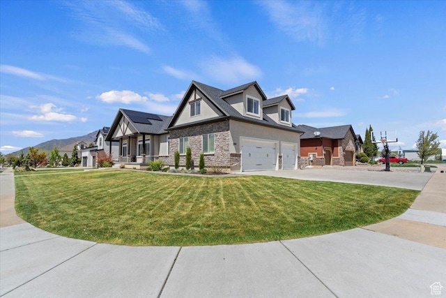 5707 Scenic Ln, Mountain Green, UT 84050 - view of front facade featuring stone siding, a garage, a front yard, concrete driveway, and a mountain view