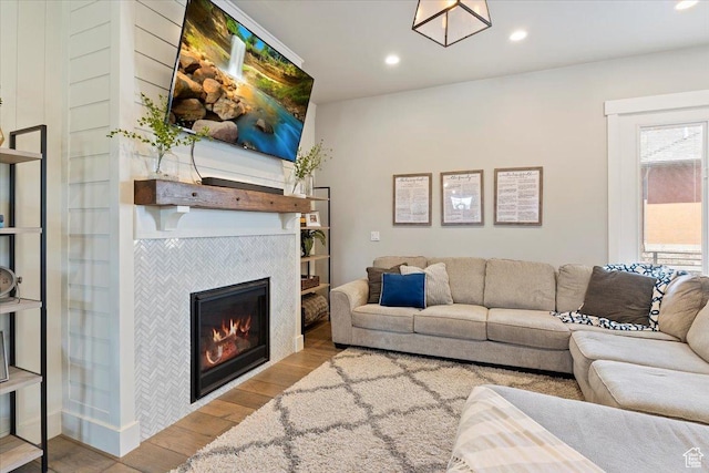 5707 Scenic Ln, Mountain Green, UT 84050 - living room with wood finished floors, a tiled fireplace, and recessed lighting