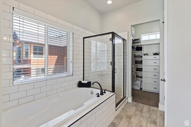 5707 Scenic Ln, Mountain Green, UT 84050 - full bathroom featuring a walk in closet, a garden tub, a shower stall, and healthy amount of natural light