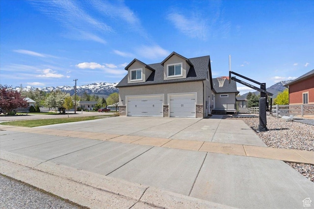 5707 Scenic Ln, Mountain Green, UT 84050 - view of front facade featuring concrete driveway, a mountain view, roof with shingles, and stucco siding